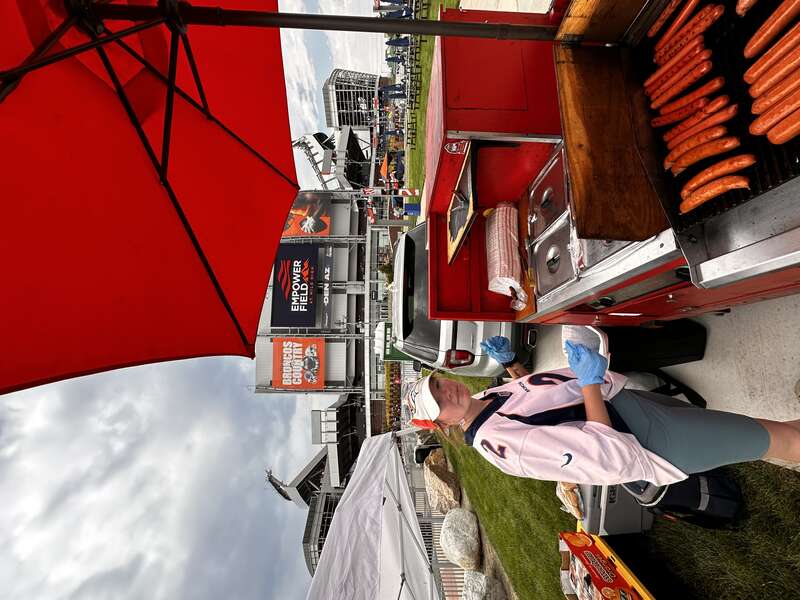 Grilling hot dogs at a Denver event