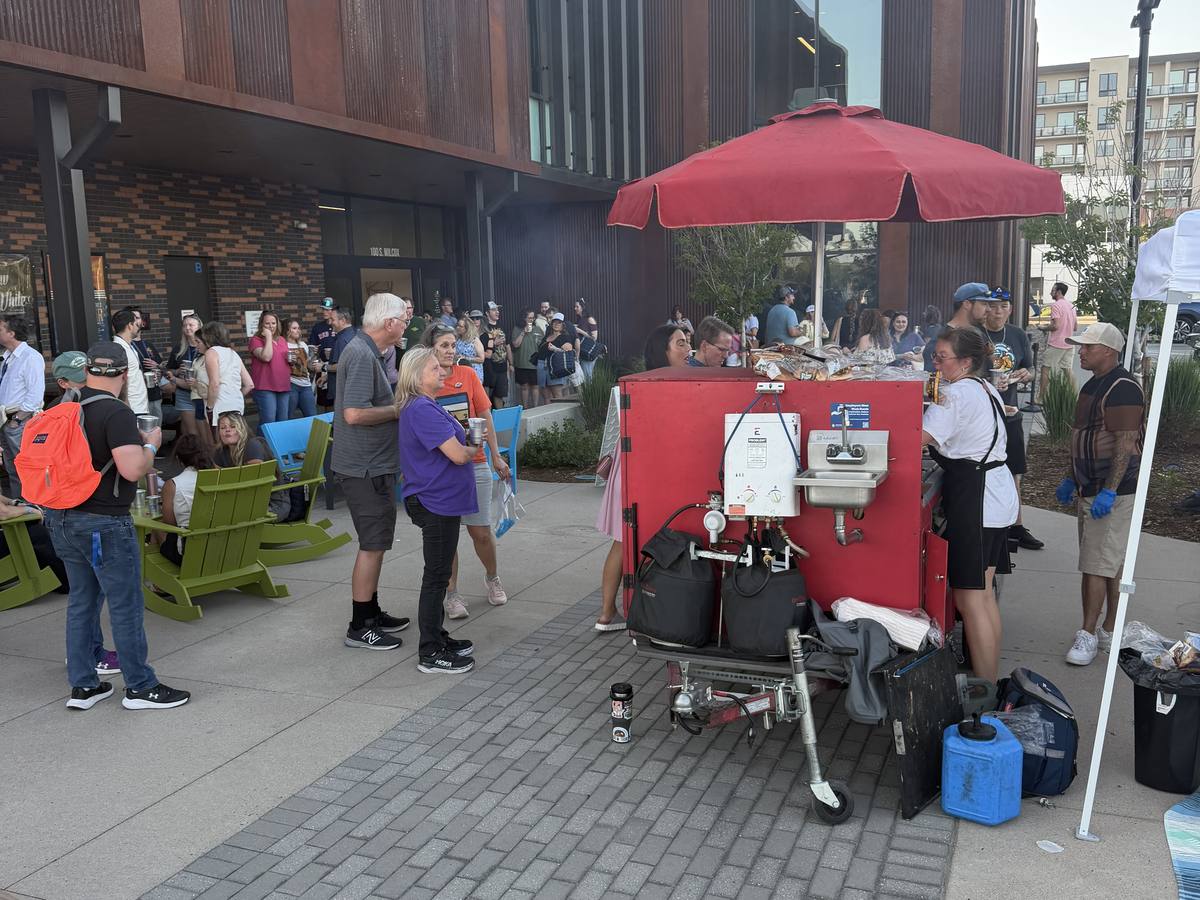 Crowd gathered around the Devil Dog Grill cart at an outdoor event