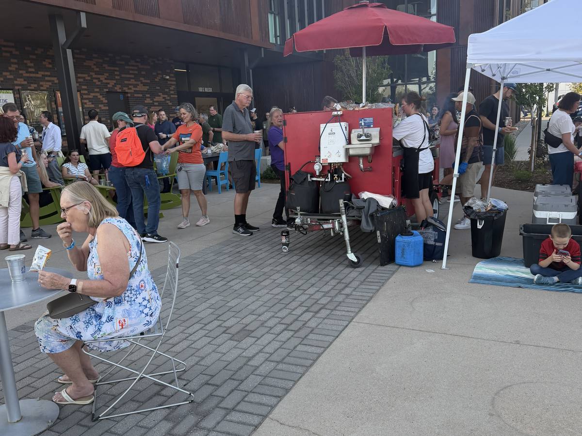 Guests enjoying food near the Devil Dog Grill cart